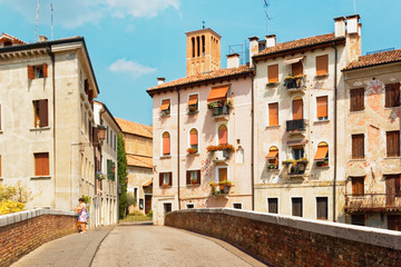 Fototapeta na wymiar Treviso, Italy August 7, 2018: Beautiful street with old buildings.