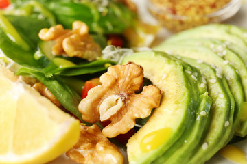 Delicious fresh salad with walnuts, closeup