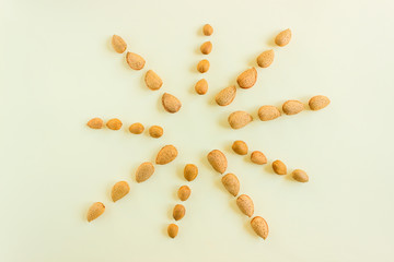 Creative and minimalist composition layout of almonds nuts. Concept- healthy lifestyle, vegetarianism, raw food, vegetable protein.