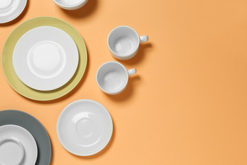 Set of clean tableware on color  background