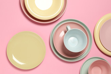 Set of clean tableware on color  background