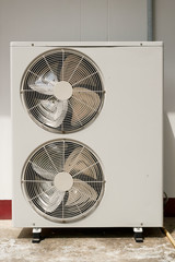 Double Fan Horizontal Outdoor Condensing Unit At a Wall