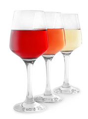 Glasses of tasty wine on white background