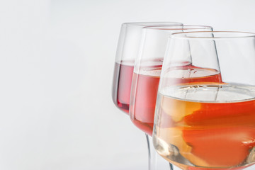 Glasses of tasty wine on white background, closeup