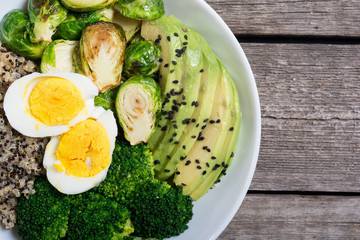 Buddha bowl with quinoa , eggs , avocado , brussels sprouts and broccoli