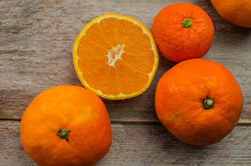 Fototapeta na wymiar tangerines, peeled tangerine and tangerine slices on a white wooden table