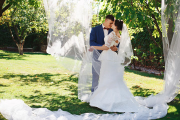 Just married loving hipster couple in wedding dress and suit in the park. Happy bride and groom...