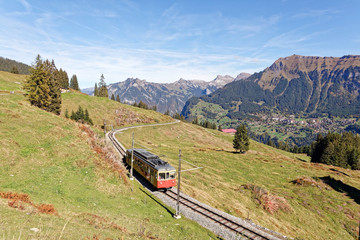 Obraz na płótnie Canvas Panoramatic view of Jungfrau Region with incoming train from Gruetschalp (Grütschalp) near Winteregg, Jungfrau Region, Switzerland