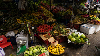 Many exotic fruits and vegetables on a market in the streets in Danang, Vietnam