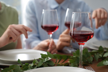Glass of red wine on table set for party