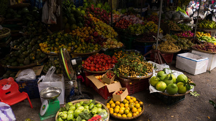 Many exotic fruits and vegetables on a market in the streets in Danang, Vietnam