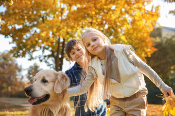 Cute children with dog in autumn park