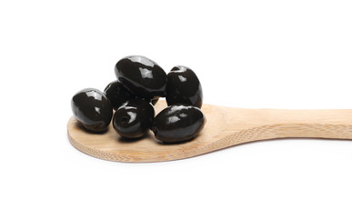 Black olives in wooden spoon isolated on white background