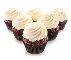 Tasty chocolate cupcakes on white background