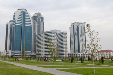 Fototapeta na wymiar Grozny, Russia: 10.07.2015. Daily life in Chechen Republic. View of the park and skyscrapers complex Grozny City