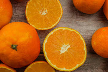 tangerines, peeled tangerine and tangerine slices on a white wooden table