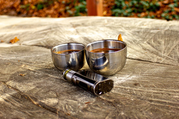 Electronic cigarette mod, advanced e-cigarette in nature ambient.  E-cigarette with blurred...