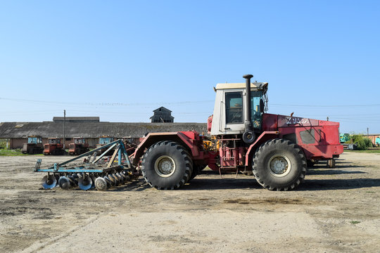 Russia, Temryuk - 15 July 2015: Tractor. Agricultural machinery tractor. Parking of tractor agricultural machinery. The picture was taken at a parking lot of tractors in a rural garage on the