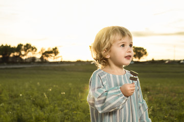 Portrait of a little girl in the countryside at sunset