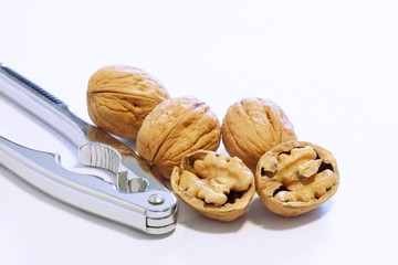 walnut and a nut cracker isolated on white background with copy space