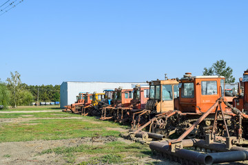 Obraz premium Russia, Temryuk - 15 July 2015: Tractor. Agricultural machinery tractor. Parking of tractor agricultural machinery. The picture was taken at a parking lot of tractors in a rural garage on the