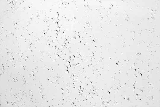 Blured water drops on window in black and white.