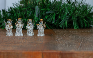 Christmas decoration. Crystal angels ornaments. Green Tinsel. Wooden Background. Copy Space