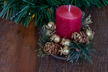 Christmas decoration. Red glitter candle. Wooden Background.  Copy Space