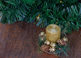 Christmas decoration. Golden glitter candle. Wooden Background.  Copy Space