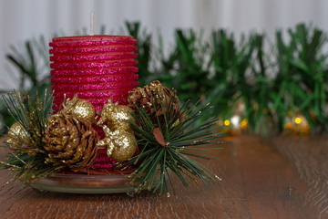 Christmas decoration. Close up red glitter candle. Wooden Background.  Copy Space
