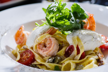 Tagliatelle with shrimps, arugula, tomatoes and Philadelphia cheese.