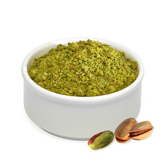 Ground, milled, granulated or crushed pistachios in bowl isolated on white background