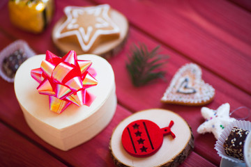 Cup of chocolate with marshmallow, gingerbread cookies, gifts and beautiful Christmas decorations on the wooden background. Flat lay, top view, space for a text.