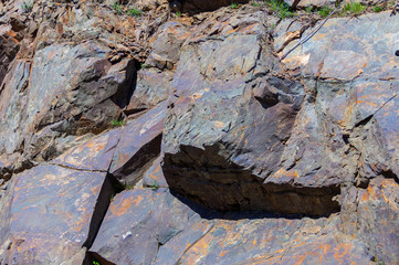 Dark stone rocks by day