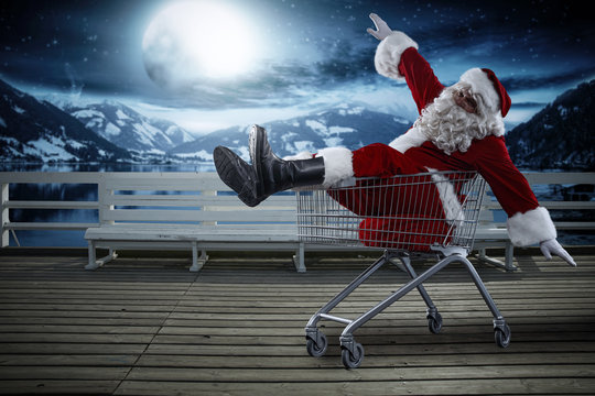 Santa Claus on wooden pier and winter night. Free space for your decoration. 