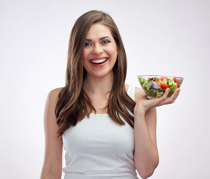 isolated portrait of smiling woman holding vegetable salad.
