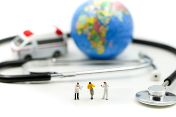 Miniature people: Doctor and patient standing with ambulance and stethoscope ,healthcare concept.