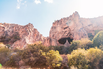 Big dry canyon and a cave inside the rock. Dry desert, national park, panoramic place is famous for hiking and picnics.