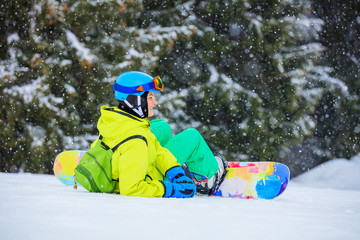 Girl snowboarder enjoys the winter ski resort.