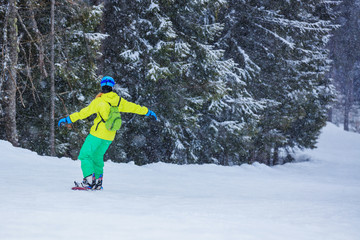 Girl snowboarder enjoys the winter ski resort.