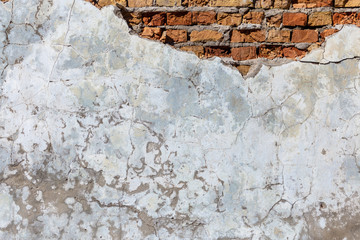 The texture of the old wall with destroyed plaster