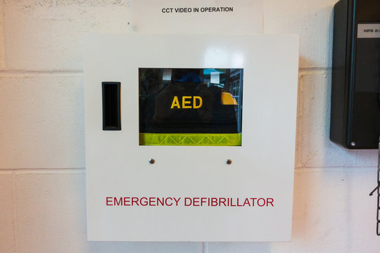 AED (Automated Extenal Defibrillator) - Heart Defibrillator Hanging On The Wall In International School Or Office Location For Prepared To Provide Life-saving