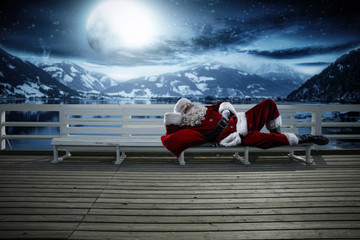 Santa Claus on wooden pier and winter night. Free space for your decoration. 