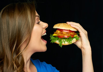 Woman eat burger. Close up face portrait