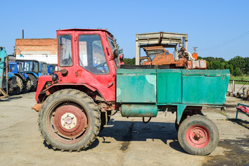 Obraz premium Russia, Temryuk - 15 July 2015: Agricultural machinery tractor. Tractor beggar. tractor with front body. The picture was taken at a parking lot of tractors in a rural garage on the outskirts of