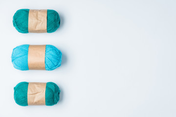 flat lay with arranged blue yarn clews on white background