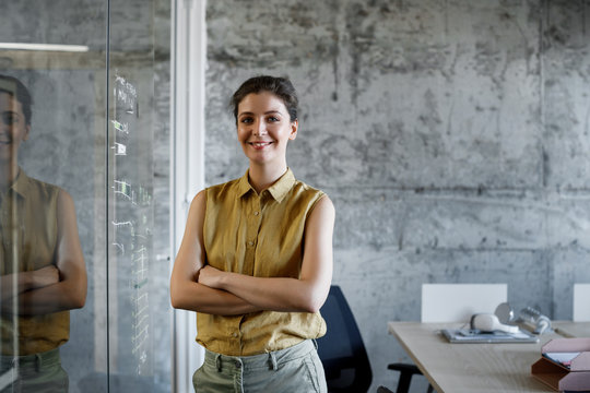 Portrait of pretty Caucasian businesswoman smiling and looking at camera.