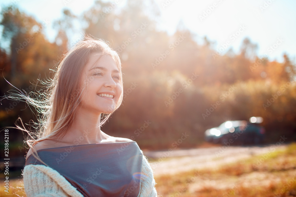 Poster pretty girl posing on camera and enjoying sunny autumn day.