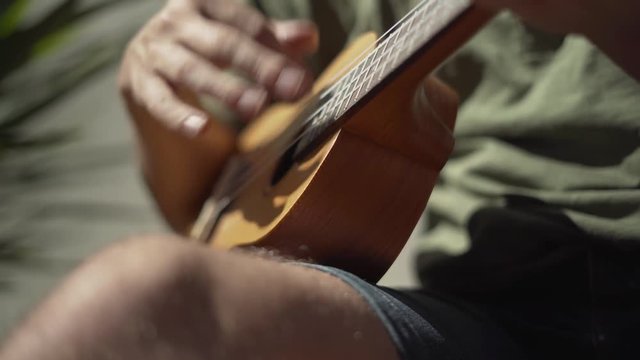 Close Shot of Man Playing Ukulele Outside