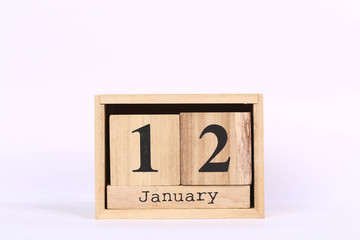 Wooden cubes calendar with the date of January 12. Concept calendar for year with copy space isolated on white background